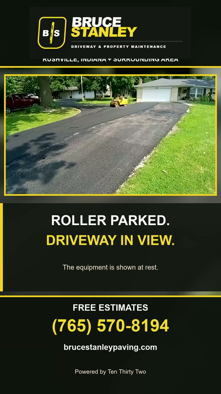 Fresh asphalt driveway with the roller parked after the work